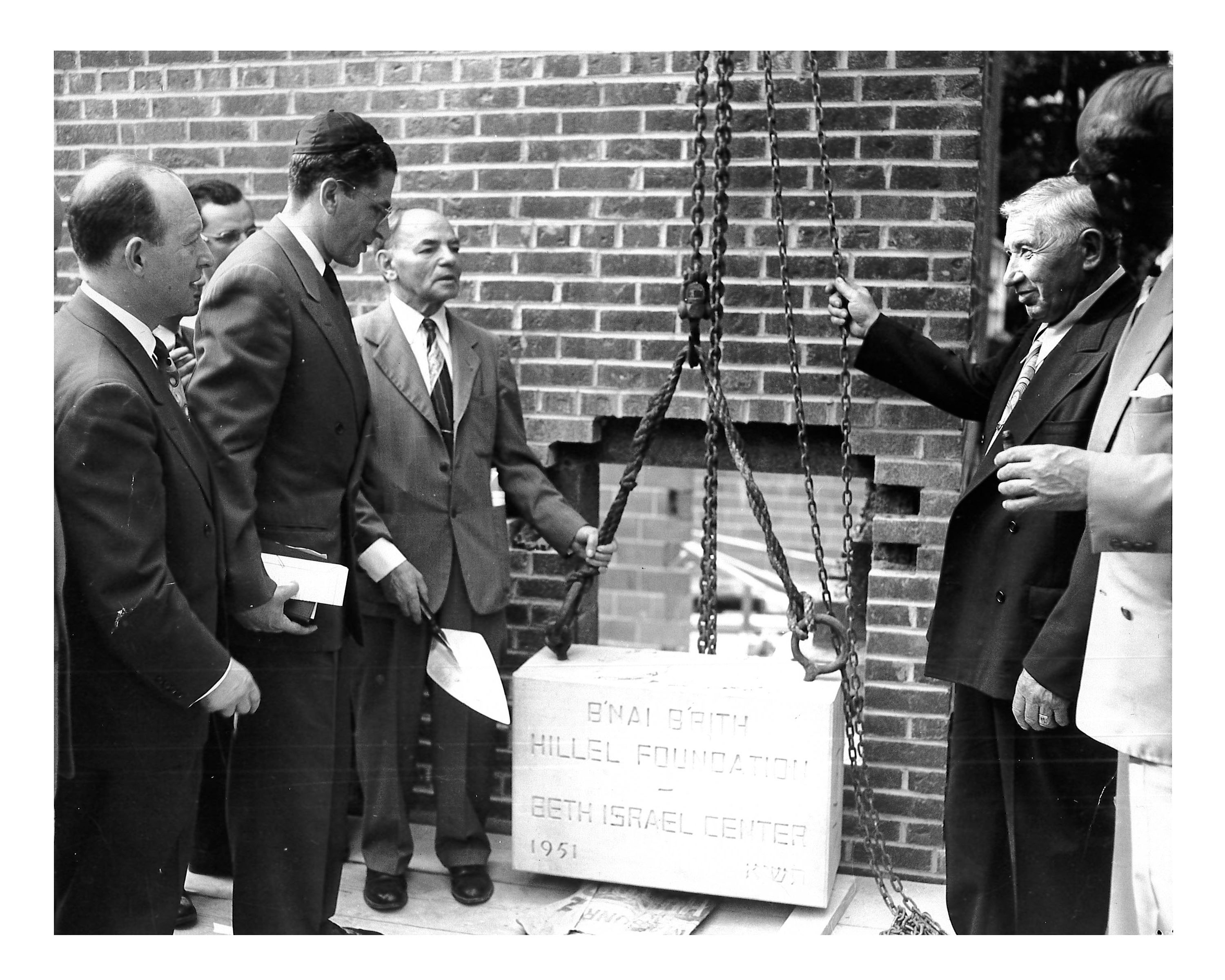 Laying the cornerstone, 1429 Hill Street, 1951. Herb Schlager (left), Rabbi Herschel Lyman (tall man), Osias Zwerdling (holding the rope), Tom Cook (holding the chain).